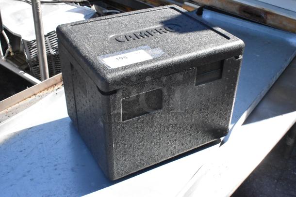 Cambro black insulated box, excellent condition, embossed logo, used for storing and transporting food, auction tag visible.