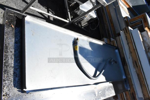 Durable stainless steel table with slight surface wear, gas hose attached marked "GAS," suitable for commercial use.