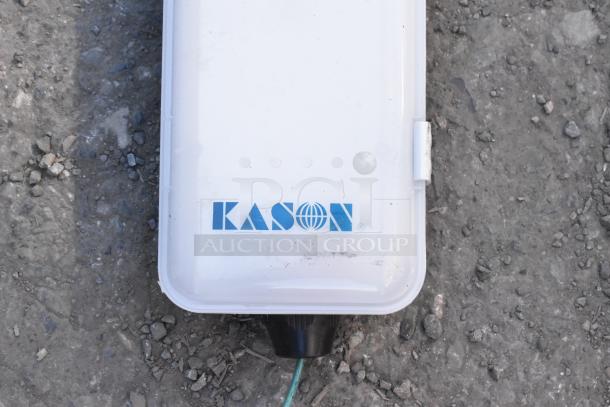 Kason light fixture with logo on white casing, slightly worn. Auction includes two fixtures.