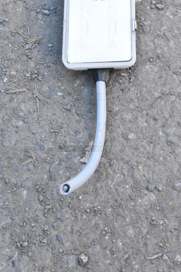 Kason light fixture with LED panel, flexible conduit attached, appears in good condition.