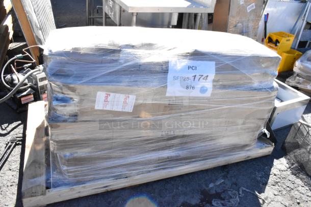 Shrink-wrapped pallet with 16 brand new scratch and dent items, including Lancaster table base column and Lavex towel dispenser.