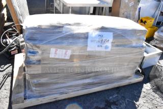 Shrink-wrapped pallet with 16 brand new scratch and dent items, including Lancaster table base column and Lavex towel dispenser.