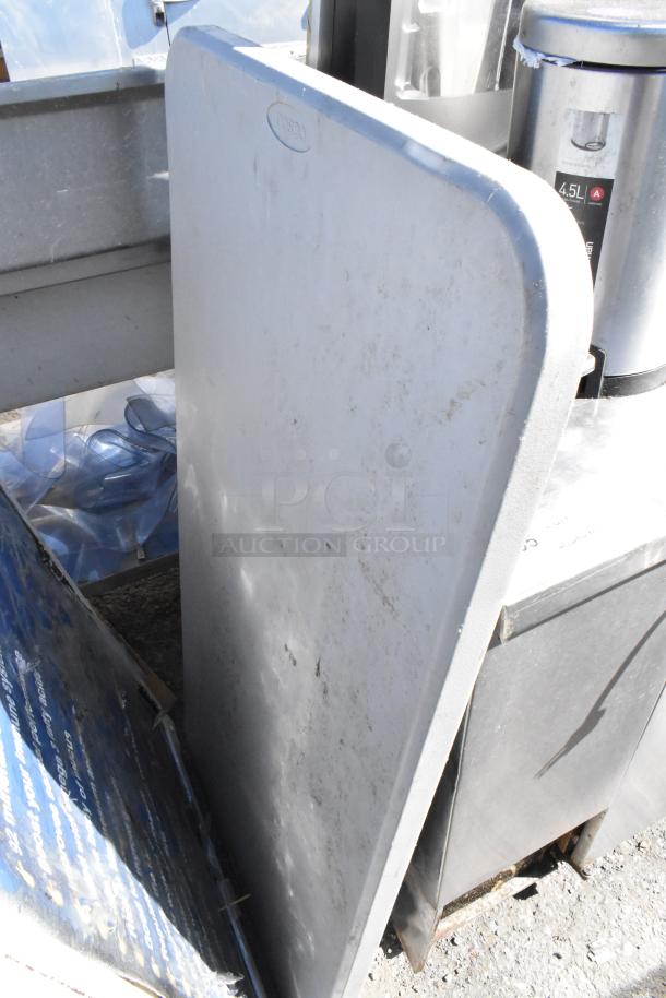 Mixed items including a white folding table. Visible wear and dirt. Label reading "COSCO." Positioned outdoors.