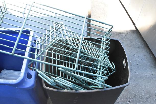 Two poly bins filled with assorted wall mount storage unit pieces, including metal racks. Bins are blue and black.