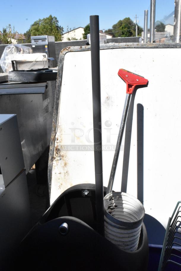 Two poly bins containing wall mount storage unit pieces and assorted items, shown outdoors.