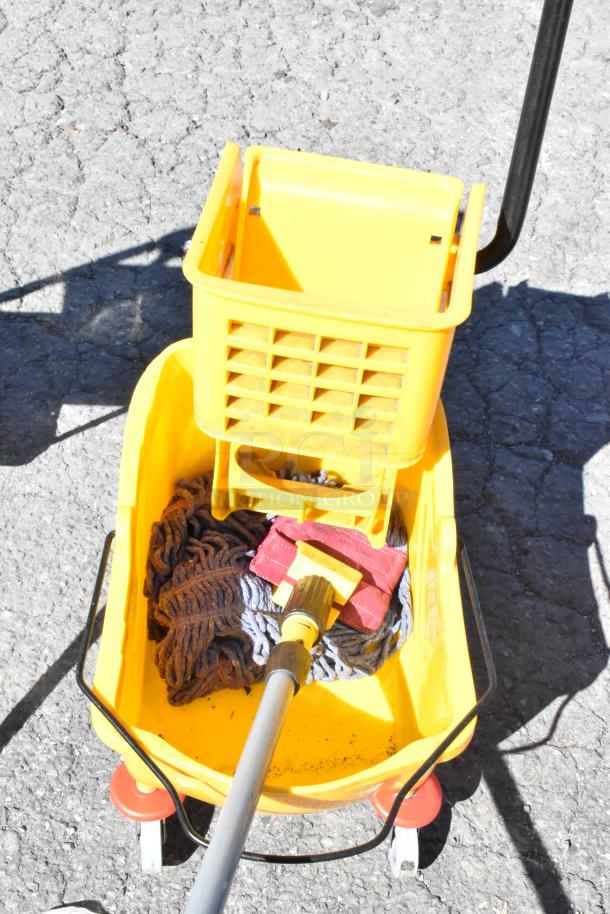 Yellow Lavex mop bucket with wringer, mop, and handle; red casters. Suitable for commercial cleaning. Good condition.