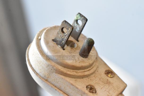 Close-up of a slightly corroded 115V plug from the Fleetwood DR-400 Bread Slicer, showing wear and metal prongs.