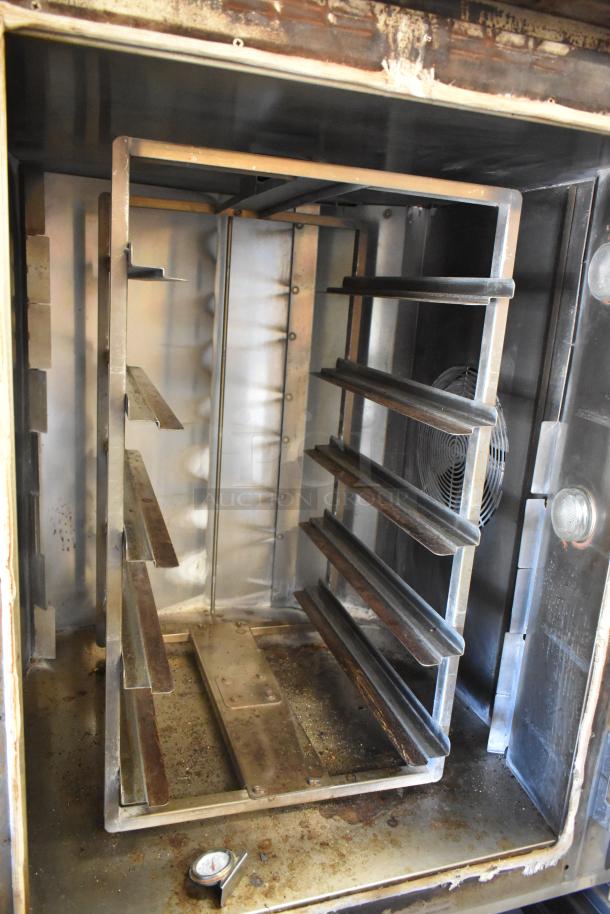 Baxter stainless steel commercial natural gas powered mini rotating rack oven with double pan rack and commercial casters.