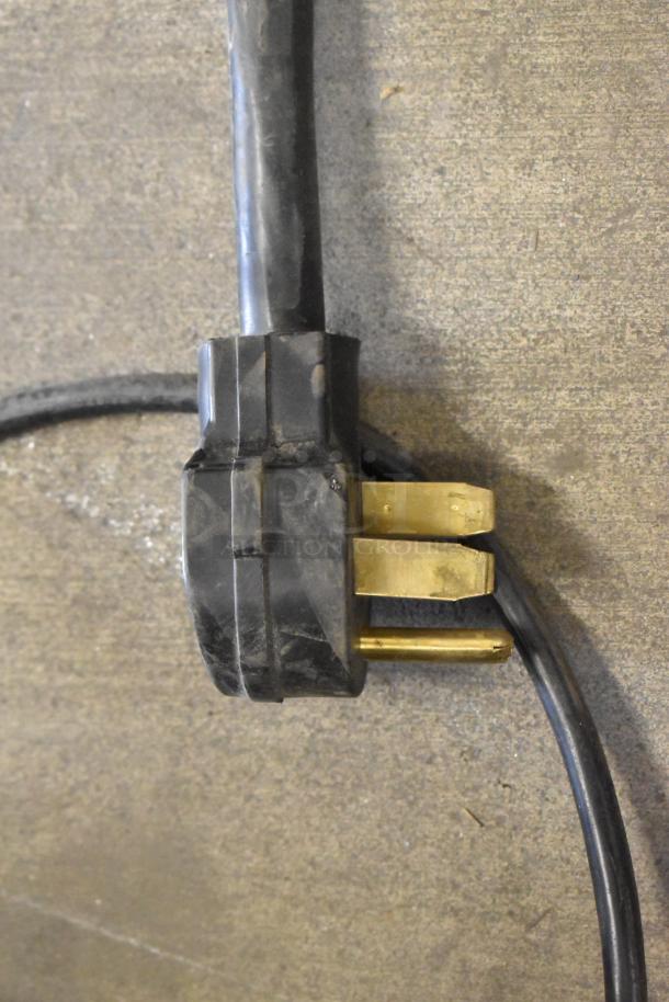 Black and brass power plug for SuperSystems OP-3 Electric Oven Proofer, 120/208V, 3 phase, showing sturdy construction.