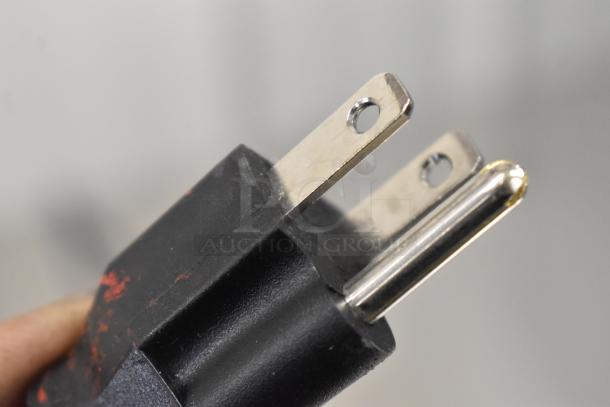 Close-up of a plug from a scratch and dent Avantco 178SSUC36RHC stainless steel undercounter cooler, 115V, 1-phase.