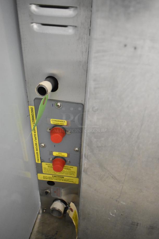 Alt text: Close-up of Cleveland 22CGT6.1 SteamChef steamer controls, showing labeled red knobs and water connections.