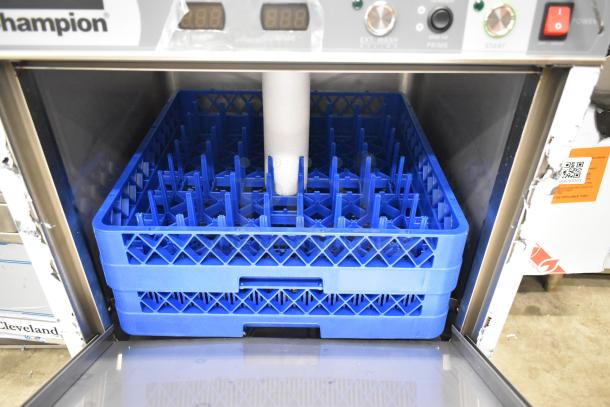Brand new 2025 Champion UH130B-70 stainless steel undercounter dishwasher showing interior with blue dish racks.