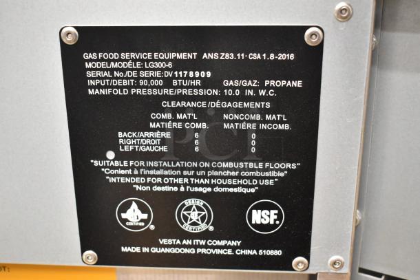 Label on stainless steel Superior LG300-6 fryer shows model, serial number DV1178909, 90,000 BTU, propane gas, NSF certified.