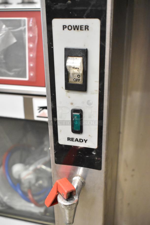 Fetco CBS-51H15 stainless steel coffee machine with hot water dispenser, power switch, and red tap visible.