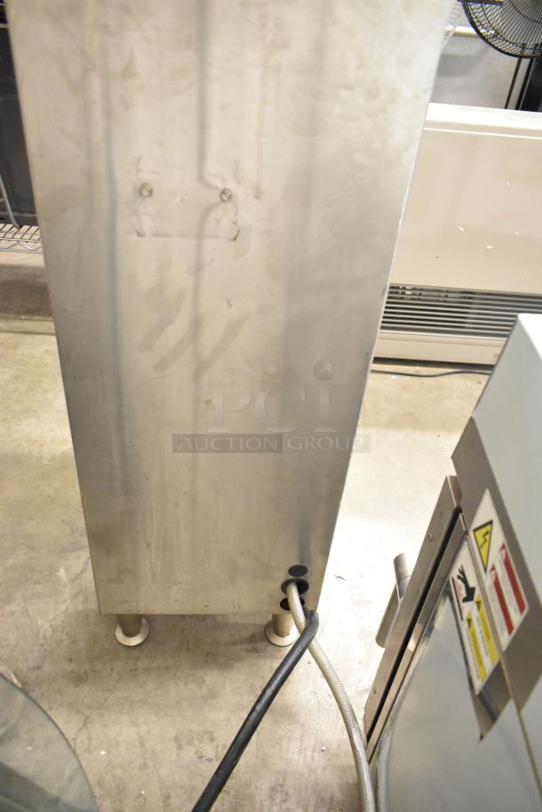 Fetco CBS-51H15 stainless steel coffee machine with hot water dispenser, features visible cords and warning labels.