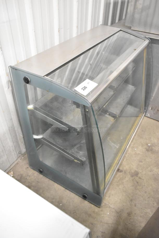 Metal commercial countertop display case with glass panels, stainless steel top, and multiple shelves; item number 226 visible.
