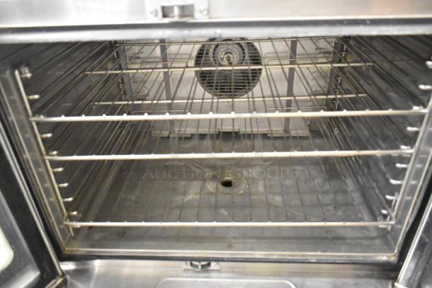 Blodgett Helix stainless steel convection oven with view-through doors and metal racks. Good condition, ideal for commercial use.
