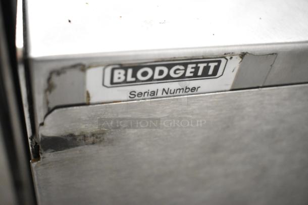 Blodgett Helix convection oven, stainless steel with view-through doors, includes metal racks. Serial number label visible.