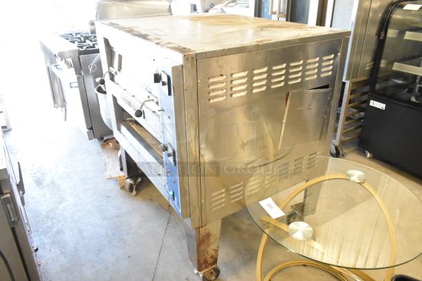 Bakers Pride EP-2-2828 stainless steel 2-deck pizza oven on casters, electric, 208V, 1 phase. Used condition, visible wear.