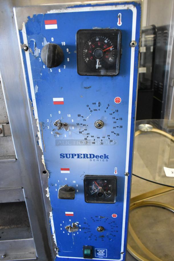 Bakers Pride EP-2-2828 Super Deck commercial pizza oven controls, visible wear, blue panel with temperature dials and settings.