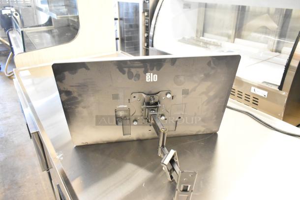 Elo monitor with mounting arm, visible wear on back panel, logo centered. Suitable for retail or touch applications.
