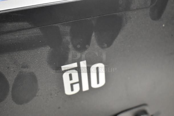 Elo Monitor, black casing, visible logo, some smudges on surface. Ideal for touch display needs, precise input.