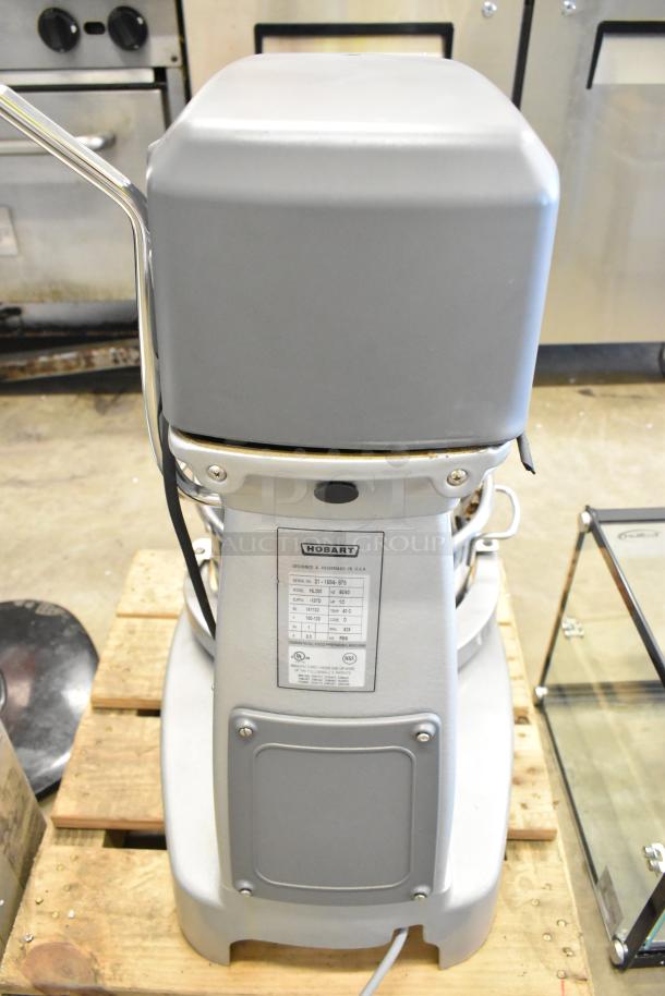 Brand new Hobart Legacy HL200 20 Qt mixer; includes bowl, guard, whisk; visible labels specify model, 100-120V power.