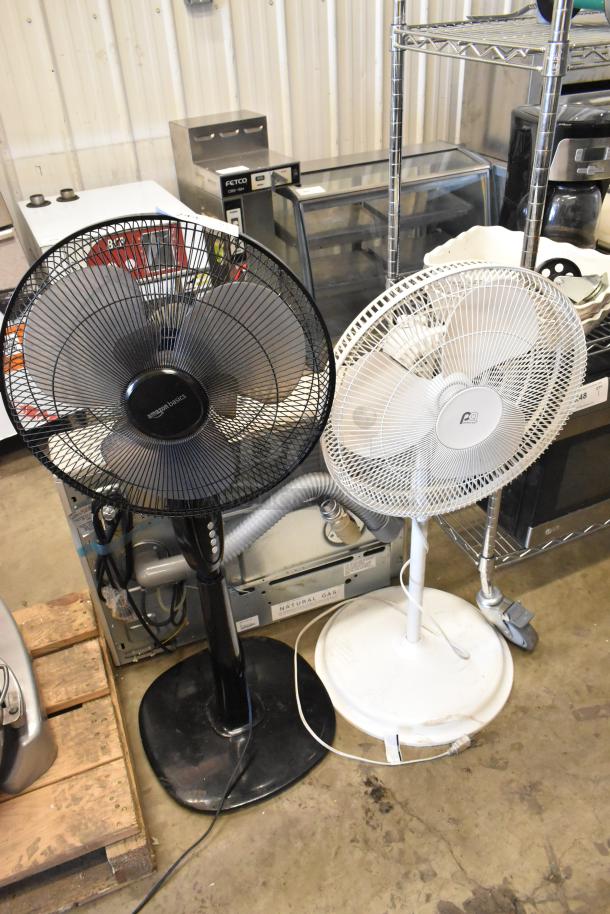 Two floor fans, black and white, 120 volts, 1 phase, in good condition. Includes Amazon Basics model. 2 times your bid offer.