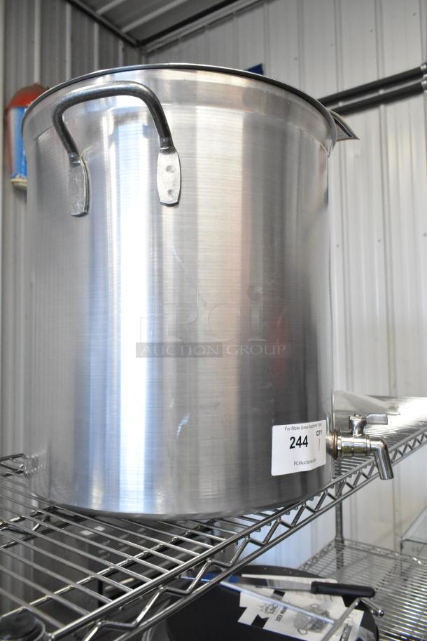 Brand new Vollrath 60-quart aluminum stock pot, with minor scratches, shown on wire rack with attached spout and label.
