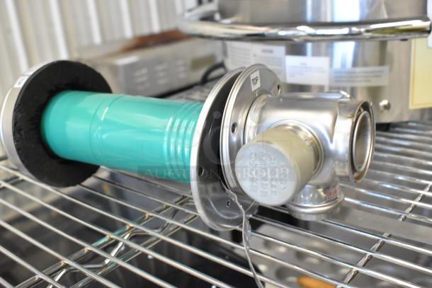 Brand new metal intake unit with minor scratches, turquoise tube, and visible labels. Marks indicate orientation and specifications.