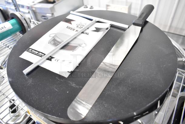Carnival King 382TCMPT16A stainless steel 16" round crepe maker, non-stick, with user manual, spatula, and spreader.