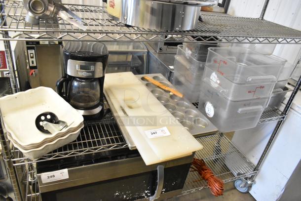 Tiered lot with poly bins, muffin baking pan, cutting boards, and a coffee maker on metal shelving. Used condition.