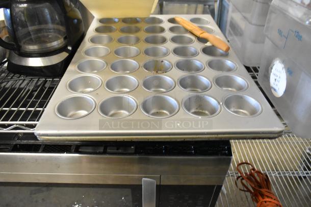 ALL ONE MONEY! Tier Lot with poly bins, muffin baking pan, cutting boards; visible wear, ideal for kitchen use.
