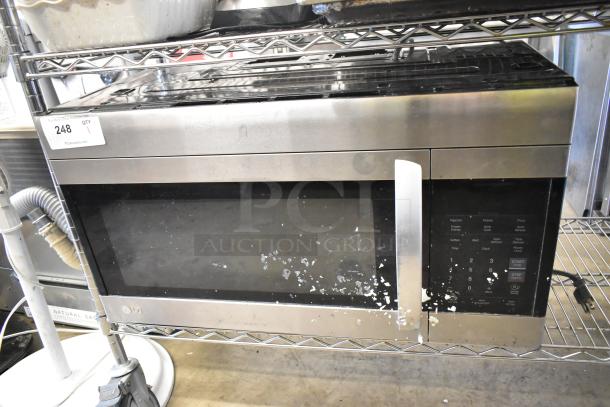 LG LMV1762ST stainless steel microwave oven, 120 volts, 1 phase, visible wear on the front, includes plate.