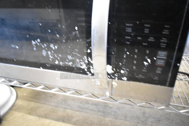 LG LMV1762ST stainless steel microwave oven with visible surface stains. Model features a handle and control panel. 120 volts, 1 phase.
