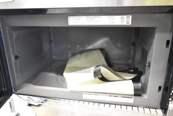LG LMV1762ST stainless steel microwave interior, clean condition, includes plate, 120 volts, 1 phase, with visible label.