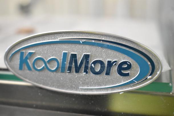 Alt Text: Close-up of KoolMore logo on a DC-2C Countertop Dry Display Case Merchandiser. Brand new with minor scratches.