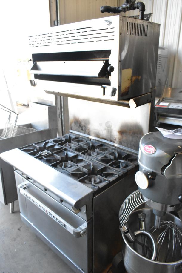 American Range stainless steel 6-burner gas range with oven, salamander cheese melter, and back splash; commercial kitchen use.