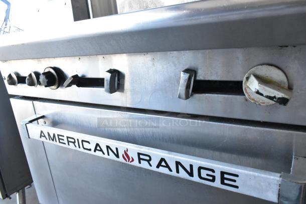 American Range stainless steel commercial 6-burner gas range with oven, salamander cheese melter, and backsplash.