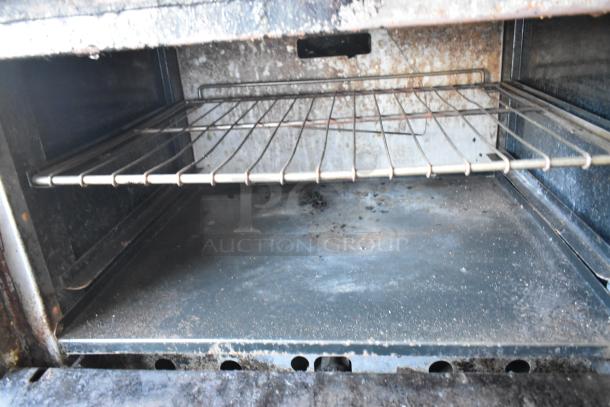 American Range gas-powered stainless steel commercial oven interior, showing wear; includes 6 burners, salamander, back splash.