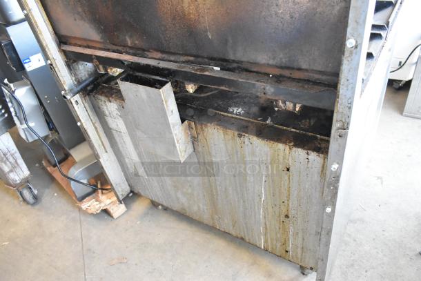 American Range stainless steel commercial gas-powered 6 burner range, oven, salamander cheese melter, with visible wear and rust.