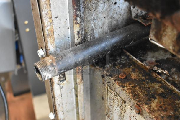 Close-up of American Range gas-powered oven component with visible wear and rust, indicating used condition.