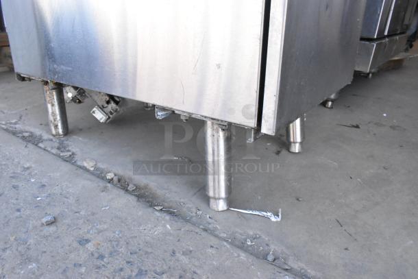Cecilware stainless steel commercial floor deep fat fryer, features two metal fry baskets, visible surface wear on legs.