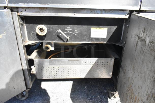 Giles EOF-24 stainless steel 3-bay electric deep fat fryer with dumping station, on casters, showing controls and drainage area.