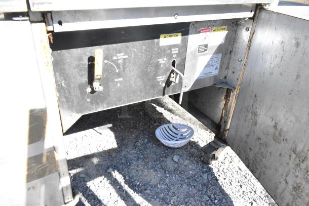 Giles EOF-24 stainless steel commercial electric 3-bay deep fat fryer with dumping station, visible condition and labels.