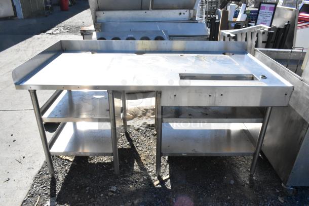 Stainless steel soda station with under shelves, featuring a spacious work surface, storage shelves, and durable legs.