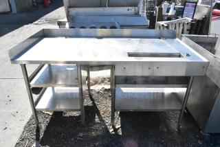 Stainless steel soda station with under shelves, featuring a spacious work surface, storage shelves, and durable legs.