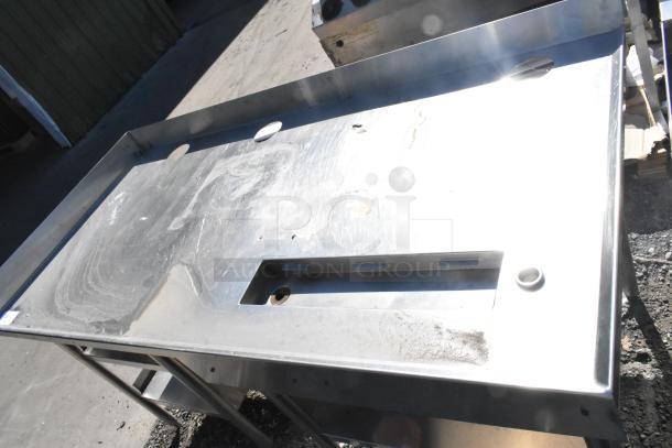 Stainless steel soda station with undershelves, used condition, visible surface scratches, and cutouts for fixtures.