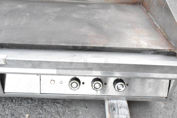 Lang 172T-480V stainless steel electric flat top griddle, 480V, 3-phase, commercial use, visible wear, control knobs shown.