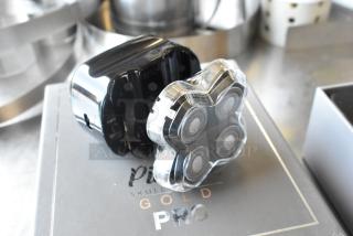 Brand new Pitbull Gold Pro PBG4-8700 head and face shaver, featuring four rotary blades, sleek black design, and original packaging.
